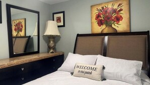 A neatly made bed with a pillow that reads "WELCOME to our patch." - Anchors Way Inn (Anchorage)
