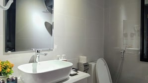 A modern bathroom with a large white sink, a mirror, a toilet, and a shower. - Hanoi Lucky Hotel (Hanoi)
