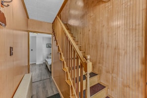 A wooden staircase with a handrail leading to a landing. - Downtown Lincoln Basecamp! (Lincoln)