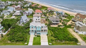 A coastal residential area with houses, a beach, and a view of the ocean. - Beachfront 5BR | Ocean Views, Elevator & Game Room (Palm Coast)