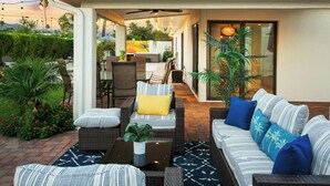 An outdoor patio with wicker furniture, a ceiling fan, and a view of the cityscape. - SWSS 4BR Kierland Luxury Escape | Heated Pool, Game Room, Putting Green (Scottsdale)