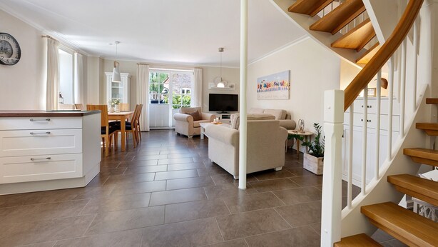 A spacious living area with a kitchen, a dining area, and a staircase. - Holiday Home 'Huus Alex' with Private Terrace, Private Garden and Wi-Fi (St. Peter-Ording Dorf)