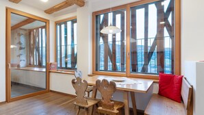 A room with wooden furniture, large windows, and a view of the outdoors. - Apartment 'Schloss Gravetsch Castel' with Mountain View and Shared Garden (Villandro)