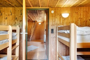A wooden interior with bunk beds, a hallway, and a light fixture. - Robbers’ Cabin at Feldberg – Rustic Black Forest Group Lodge (Feldberg)