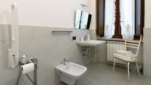 A bathroom with a bidet, sink, mirror, and window with curtains. - Room 'Camera 48' with Wi-Fi and Air Conditioning (Verona)