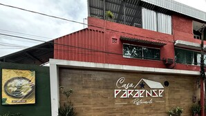 A building with a sign that reads "Casa PARANSE Restaurante" on a wooden wall. - Casa Paraense  (Manaus)