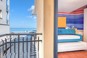 A balcony with a view of the sea, a bed with a blue headboard, and a window with a view of the sea. - Front Beach Magic Sea - Sea Front, Laigueglia, Italy (Laigueglia)