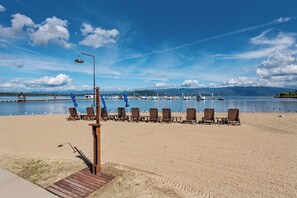 Relax on the beach with a clear view of the water and distant mountains.