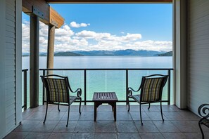 Enjoy a serene view of the lake and surrounding mountains from this balcony.