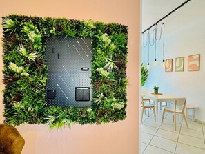 Experience a natural oasis with a lush vertical garden wall and dining area.