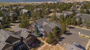 A residential area with houses, a parking lot, and a beach in the background. - SeaEscape: Cute home, dog ok, near beach & pub! (Pacific City)