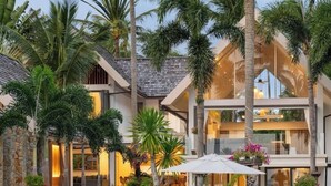 A modern multi-story house with a spacious outdoor area featuring palm trees and a white umbrella. - Best Family Beachfront Villa Koh Samui |Chef| Staff|JetSkis|Pool|No Hidden Fees| (koh samu)