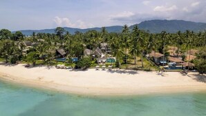 A coastal resort with beachfront villas, palm trees, and a clear view of the ocean. - Best Family Beachfront Villa Koh Samui |Chef| Staff|JetSkis|Pool|No Hidden Fees| (koh samu)
