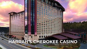 A multi-story hotel with a modern architectural design, featuring a prominent glass facade and a curved roof.