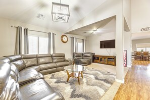 Relax in this stylish living area with a large sofa, coffee table, and flat-screen TV.