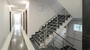 Un couloir avec un escalier menant à un palier.