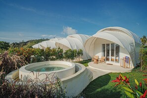 A series of dome-shaped accommodations with a hot tub and outdoor seating area. - Onion Hill Glamping (Kintamani)