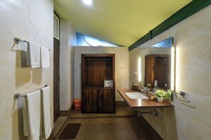 A bathroom with two sinks, a mirror, and a wooden cabinet.