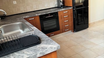 Luxury Apartment, Balcony, Garden View | Private kitchen | Highchair