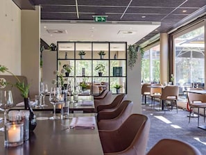 Enjoy meals in this stylish dining area with a long table and comfortable seating.
