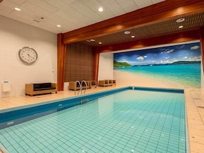 Relax by the pool with a stunning beach view.