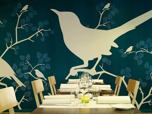 Enjoy a serene dining experience with a table set for two, featuring a wine glass and a small bowl.