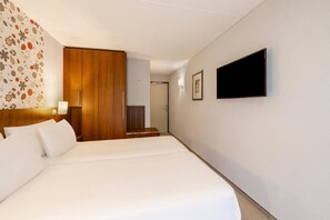 Comfortable accommodations feature a large bed, wardrobe, and flat-screen television.