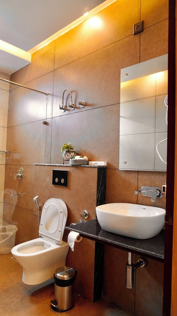 A modern bathroom with a toilet, bidet, sink, and mirror. - Nakshville (Bhimtal)