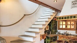 A kitchen with a stone staircase leading to a second floor. - Terrazzo Prato Pernice Apt.12 by Interhome (Orselina)