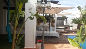 A patio area with a pool, a seating area with a sofa and cushions, and a lamp post. - Lux Villa LONG-TERM RENT for 7 ppl, Private pool, Sauna, Tennis, Gym, Golf, swim (Baños y Mendigo)