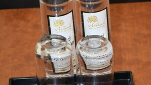 Two bottles of Vihaar Inn & Suites alcohol on a black tray. - Sai Vihaar Inn & Suites (Mysore)