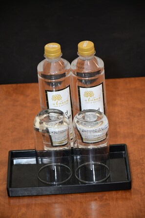 Two bottles of Vihaar Inn & Suites alcohol on a black tray. - Sai Vihaar Inn & Suites (Mysore)
