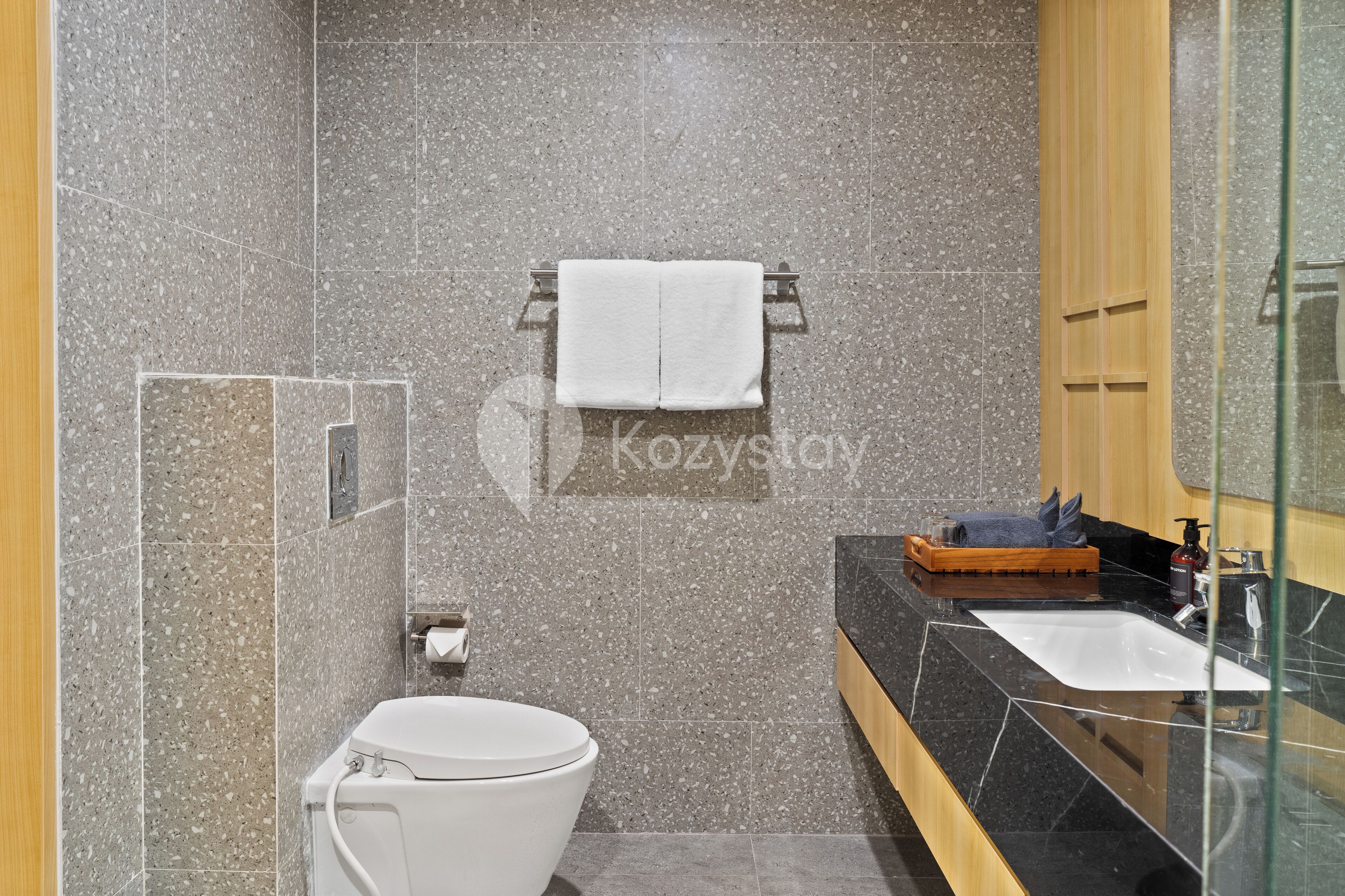 Un baño moderno con inodoro, lavabo y cabina de ducha de vidrio.