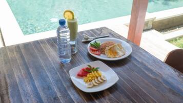 Guests can enjoy a meal with a view of the pool from this outdoor dining setting.