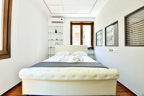 1 bedroom, desk, iron/ironing board, travel crib