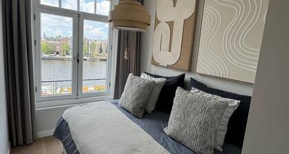 Grand Amstel Residence | Expansive Two-Story Riverfront Apartment in Central Amsterdam
