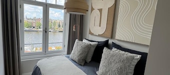 Grand Amstel Residence | Expansive Two-Story Riverfront Apartment in Central Amsterdam