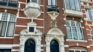 A multi-story building with a classic architectural style, featuring ornate balconies, large windows, and decorative moldings. - Grand Amstel Residence | Expansive Two-Story Riverfront Apartment in Central Amsterdam (Amsterdam)