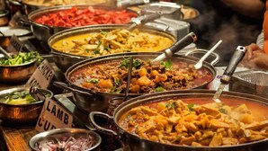 A buffet with various dishes, including a lamb curry and a vegetable dish. - Ekhaya crescent hotel mbarara (Mbarara)