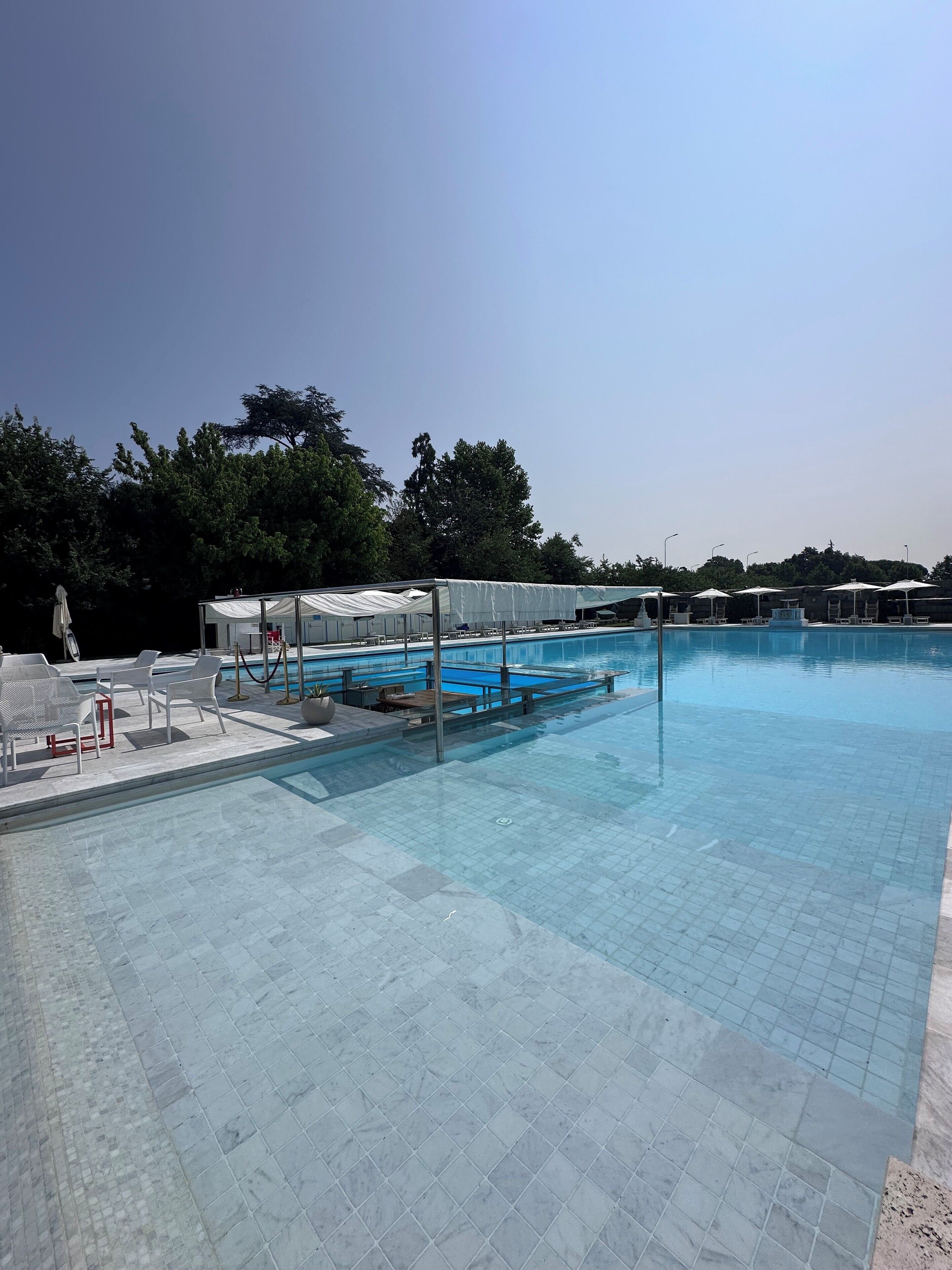 Seasonal outdoor pool, open 9:00 AM to 9:00 PM, pool umbrellas