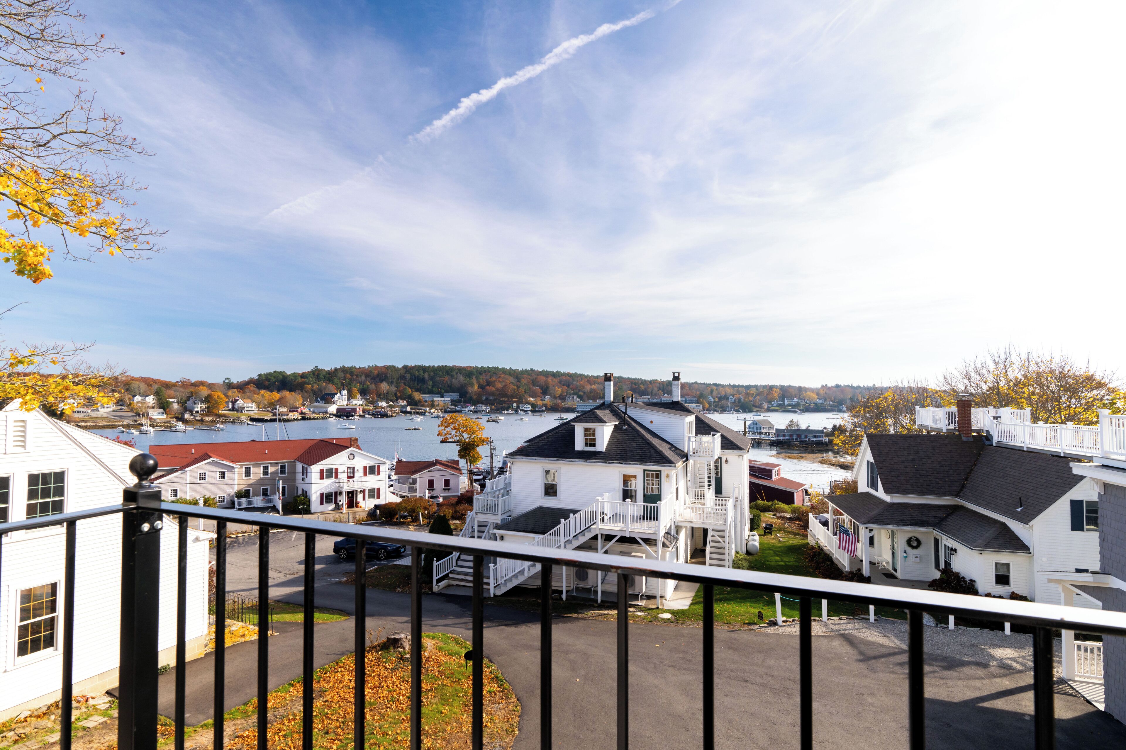 A coastal town with white houses, a dock, and a view of the water.