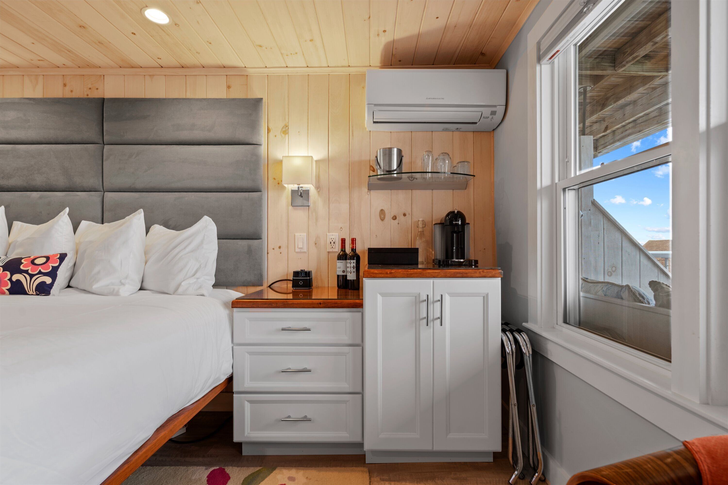 A bedroom with a bed, bedside table, and a built-in wardrobe.
