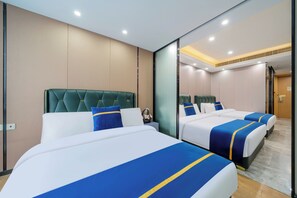 A hotel room with two beds, a green upholstered headboard, and a large mirror. - Weekend International Apartment- Beijing Rd A-mall (Guangzhou)
