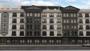 A multi-story hotel with a classic architectural design, featuring arched windows and a prominent facade. - Mara Palas Hotel (Fethiye)