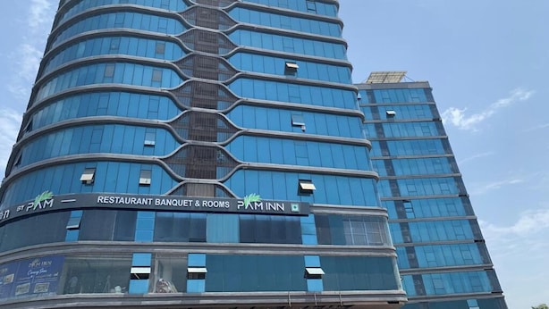 A multi-story hotel with a modern design, featuring a restaurant, banquet rooms, and a visible logo. - Pam Inn Hotel Vadodara (Vadodara)