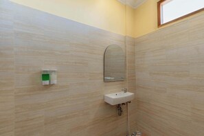 A bathroom with a sink, mirror, and soap dispenser. - Atuh Galaxy Cottage (Penida Island)