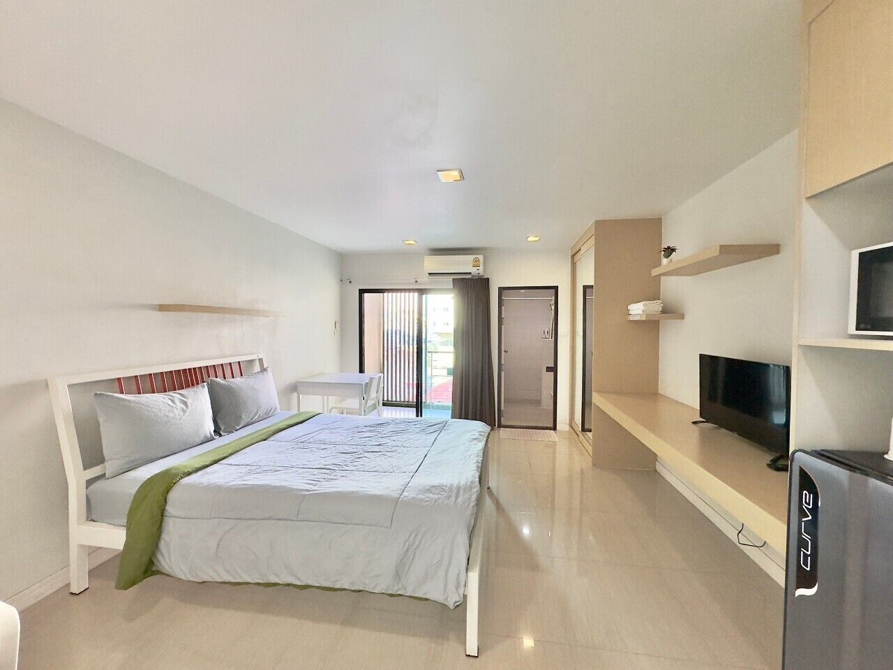 Economy Studio | Desk, laptop workspace, blackout drapes, iron/ironing board