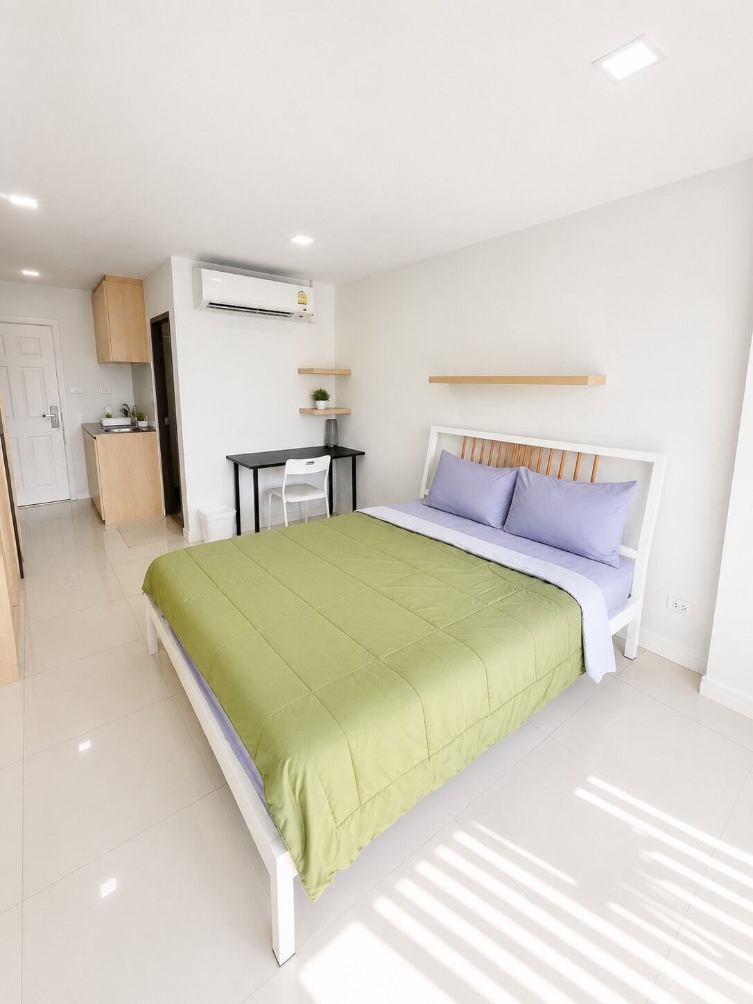 A modern bedroom with a bed, a desk, and a chair.