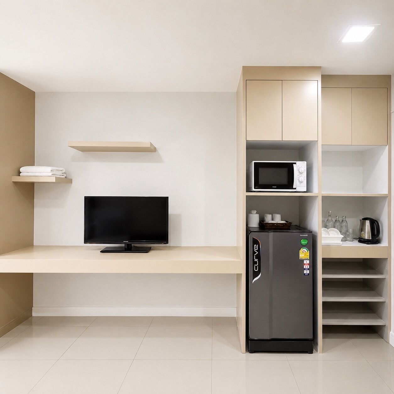 A modern kitchen with a built-in TV, a refrigerator, and a microwave.