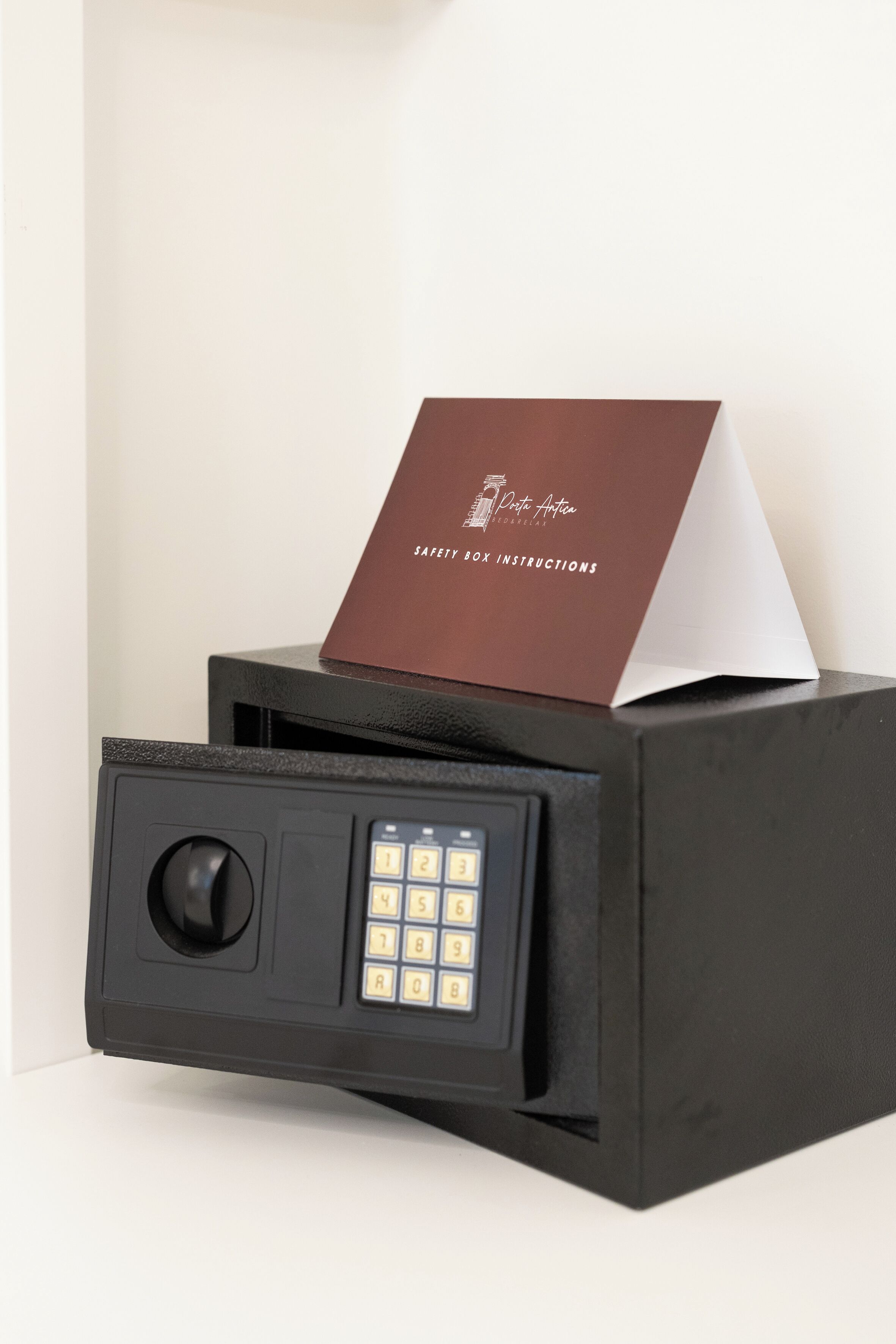 A safe deposit box with a keypad and a card inserted.